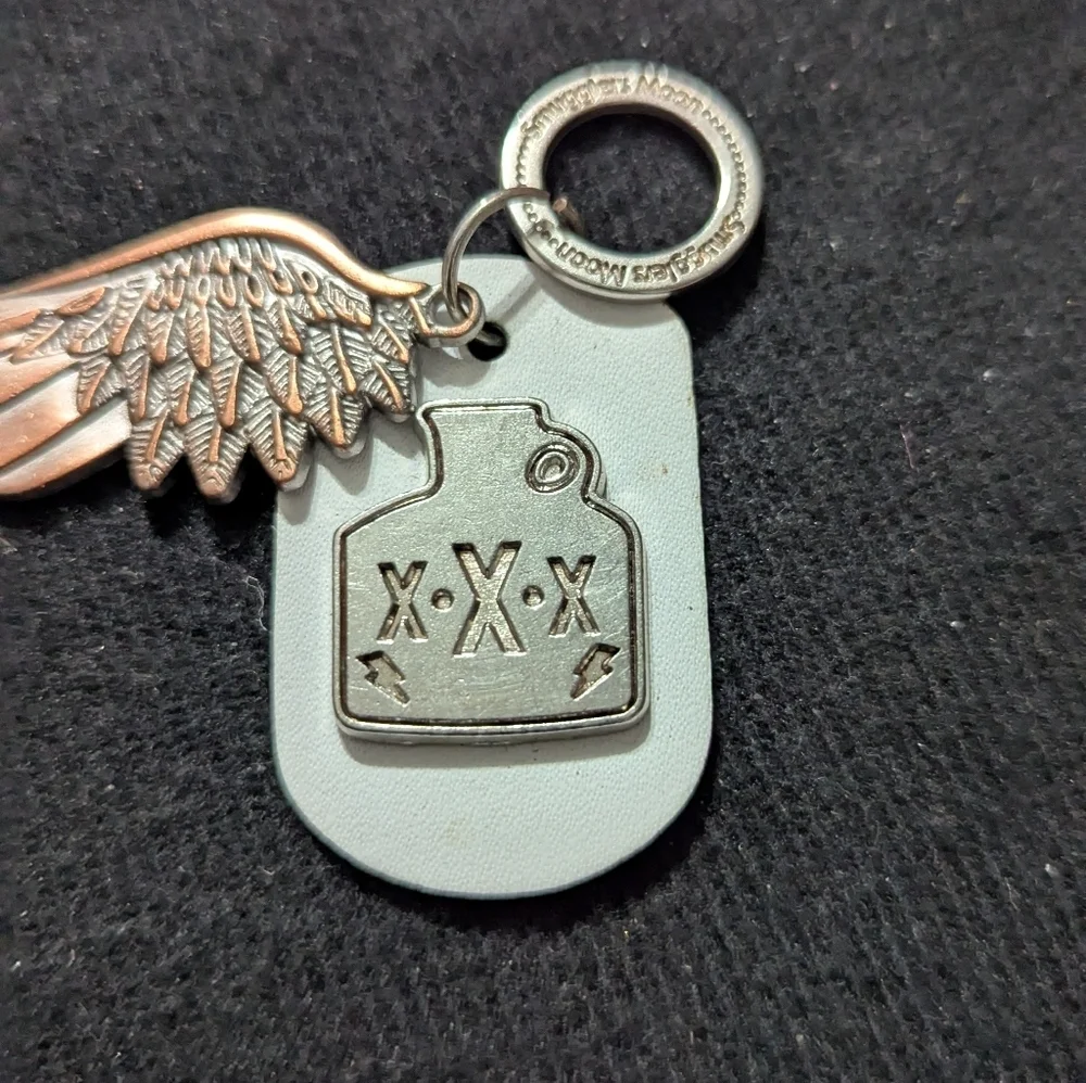 Smuggler's Moon Silver Copper Tone Wing and White Leather Moonshine Tag Keychain